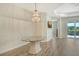 Inviting dining area featuring modern chandelier, tray ceiling and sliding glass doors at 1203 Calle Grand St, Bradenton, FL 34209