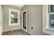 Clean entryway with decorative door, window and neutral paint with tile flooring at 1203 Calle Grand St, Bradenton, FL 34209
