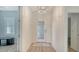 Bright foyer featuring an decorative glass front door and chandelier with tile flooring at 1203 Calle Grand St, Bradenton, FL 34209
