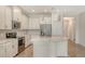 Modern kitchen featuring stainless steel appliances, an island with quartz counters, and white cabinets at 1203 Calle Grand St, Bradenton, FL 34209