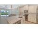 Modern kitchen featuring island, white cabinetry, stainless appliances and an open layout at 1203 Calle Grand St, Bradenton, FL 34209