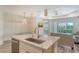 Modern kitchen features an island with granite countertops, stainless steel appliances, and stylish pendant lighting at 1203 Calle Grand St, Bradenton, FL 34209