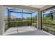 Screened lanai offering panoramic views of the manicured backyard landscaping and pond at 1203 Calle Grand St, Bradenton, FL 34209