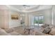Inviting living room featuring sliding glass doors, tray ceilings, and hardwood floors for ultimate comfort at 1203 Calle Grand St, Bradenton, FL 34209