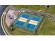 Aerial view of two community pickleball courts with an adjacent seating area at 1203 Calle Grand St, Bradenton, FL 34209