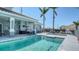 Community pool featuring an outdoor grilling area and lounge seating, perfect for entertaining and relaxation at 1203 Calle Grand St, Bradenton, FL 34209