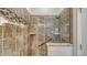 Tiled walk-in shower with a glass enclosure, built-in shelves, and modern fixtures at 1203 Calle Grand St, Bradenton, FL 34209