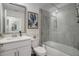 Well-lit bathroom with a combined shower and tub, white vanity, and modern fixtures at 12440 Wellen Golf St # 105, Venice, FL 34293