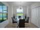 Dining area with glass table, stylish chairs, view of the water and golf course at 12440 Wellen Golf St # 105, Venice, FL 34293