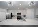 Bright kitchen features white cabinets, stainless steel appliances, and an expansive island with a sink at 12440 Wellen Golf St # 105, Venice, FL 34293