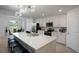 Spacious kitchen with large island, stainless appliances, pendant lighting and adjacent breakfast room at 12440 Wellen Golf St # 105, Venice, FL 34293