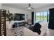 Comfortable living room with a wall mounted television, wine storage and sliding glass doors at 12440 Wellen Golf St # 105, Venice, FL 34293
