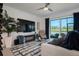 Comfortable living room with a mounted television, wine storage and sliding glass doors at 12440 Wellen Golf St # 105, Venice, FL 34293