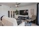 Comfortable living room features a mounted television, wine storage, and a cozy seating arrangement at 12440 Wellen Golf St # 105, Venice, FL 34293
