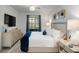 Bright main bedroom with a plush bed, stylish decor, and a calming atmosphere at 12440 Wellen Golf St # 105, Venice, FL 34293
