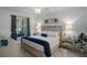 Serene main bedroom with a plush bed, elegant lighting, and decorative accents at 12440 Wellen Golf St # 105, Venice, FL 34293
