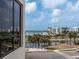 Balcony view captures cityscape, clear skies, and waterfront, framing a picturesque scene at 1255 N Gulfstream Ave # 402, Sarasota, FL 34236
