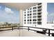 Balcony view showcases cityscape, palm trees, and clear skies, enhancing urban living at 1255 N Gulfstream Ave # 402, Sarasota, FL 34236