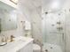 Elegant bathroom boasts marble walls, glass shower, and modern fixtures for spa-like experience at 1255 N Gulfstream Ave # 402, Sarasota, FL 34236
