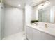 Sleek bathroom with marble walls, a glass shower, and modern gold fixtures at 1255 N Gulfstream Ave # 402, Sarasota, FL 34236
