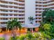 Exterior view of Bay Plaza with curved balconies, covered entry, and manicured grounds at 1255 N Gulfstream Ave # 402, Sarasota, FL 34236