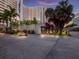 Exterior of the Bay Plaza Building featuring colorful sunset, and tropical landscaping at 1255 N Gulfstream Ave # 402, Sarasota, FL 34236