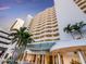 Exterior shot of the Bay Plaza building, with lush landscaping, covered entryway, and balconies at 1255 N Gulfstream Ave # 402, Sarasota, FL 34236