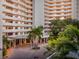 Lush landscaping surrounds the Bay Plaza entrance with covered driveway and palm trees at 1255 N Gulfstream Ave # 402, Sarasota, FL 34236