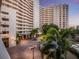 Grand entrance of the Bay Plaza featuring manicured landscaping and covered entryway at 1255 N Gulfstream Ave # 402, Sarasota, FL 34236