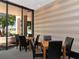 Bright common room with tables, chairs, and a view of the outdoors at 1255 N Gulfstream Ave # 402, Sarasota, FL 34236
