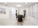 Elegant dining area features a glass table, velvet chairs, and white marble floors at 1255 N Gulfstream Ave # 402, Sarasota, FL 34236