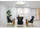 Elegant dining room with a glass-top table and designer chairs at 1255 N Gulfstream Ave # 402, Sarasota, FL 34236