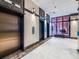 Elegant elevator lobby with marble accents and tiled flooring leading to stylish elevators and hallway at 1255 N Gulfstream Ave # 402, Sarasota, FL 34236