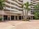 Well-maintained building entrance with brick pavers, palm trees and a covered awning at 1255 N Gulfstream Ave # 402, Sarasota, FL 34236