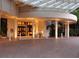 Building entrance featuring brick pavers, seating, and a covered entrance with several white columns at 1255 N Gulfstream Ave # 402, Sarasota, FL 34236