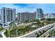 Condo building overlooking a serene pond and well-maintained landscaping at 1255 N Gulfstream Ave # 402, Sarasota, FL 34236
