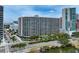 High-rise condo building with beautiful city views and lush green landscaping at 1255 N Gulfstream Ave # 402, Sarasota, FL 34236