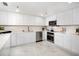 Modern kitchen features sleek white cabinetry, stainless steel appliances, and marble countertops at 1255 N Gulfstream Ave # 402, Sarasota, FL 34236