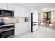 Bright kitchen features modern appliances, white cabinets, and marble countertops at 1255 N Gulfstream Ave # 402, Sarasota, FL 34236