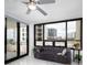 Stylish living room features a plush sofa, modern ceiling fan, and cityscape views at 1255 N Gulfstream Ave # 402, Sarasota, FL 34236