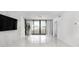 Spacious living room with light marble floors and access to a balcony at 1255 N Gulfstream Ave # 402, Sarasota, FL 34236