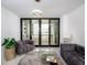 Cozy living room with modern furniture, a stylish rug, and a balcony view at 1255 N Gulfstream Ave # 402, Sarasota, FL 34236