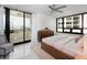 Bright main bedroom features a private balcony, stylish furniture, and city views at 1255 N Gulfstream Ave # 402, Sarasota, FL 34236
