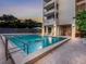 A beautiful in-ground community pool with an adjacent condominium and brick paver pool deck at 1255 N Gulfstream Ave # 402, Sarasota, FL 34236