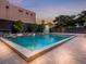 Outdoor swimming pool surrounded by pavers, mature landscaping and seating at 1255 N Gulfstream Ave # 402, Sarasota, FL 34236