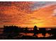 Spectacular sunset over the water, featuring vibrant orange and yellow hues at 1255 N Gulfstream Ave # 402, Sarasota, FL 34236