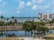 Picturesque water view of a marina and buildings from a residential community lined with palm trees at 1255 N Gulfstream Ave # 402, Sarasota, FL 34236