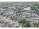 Aerial view of a quiet neighborhood near a lake, featuring manicured lawns and mature trees at 12805 Raysbrook Dr, Riverview, FL 33569