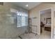 Bathroom with glass shower, tile surround, and view into bedroom at 12805 Raysbrook Dr, Riverview, FL 33569