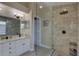 Bathroom with double sinks, granite countertops, and glass enclosed walk-in shower at 12805 Raysbrook Dr, Riverview, FL 33569